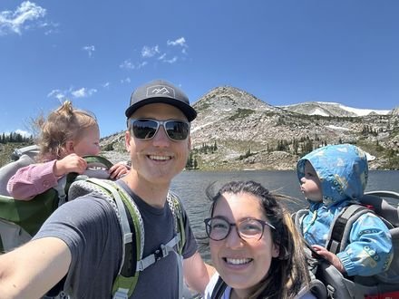 Adam and his wife hiking with both kids in carriers