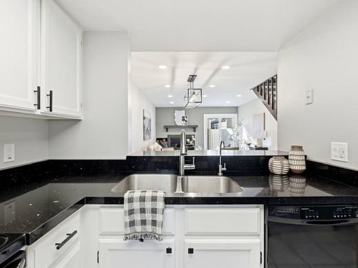 Kitchen with recessed ceiling lights and a caged pendant